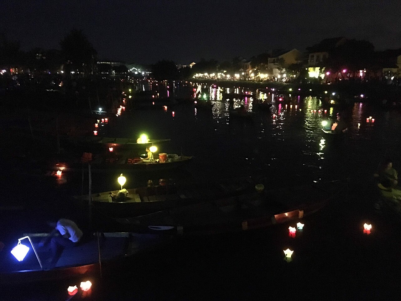 Floating lanterns and paper lanterns on the Hoai River on Hoi An's full moon night