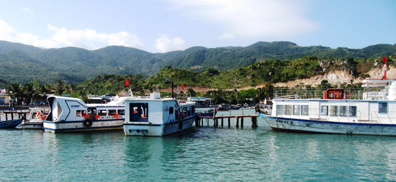 Tourist boats moored at Vinh Hy Bay pier